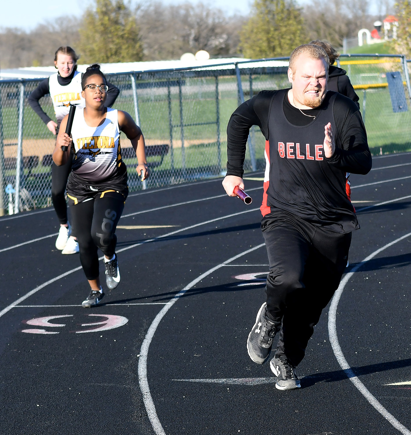 Aliyah Griffin and CJ Drewel (from left) run their legs of the 4x100-meter relay for Vienna and Belle respectively.